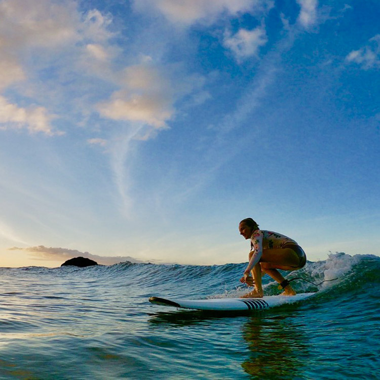 Surfeuse dans les vagues de Tahiti